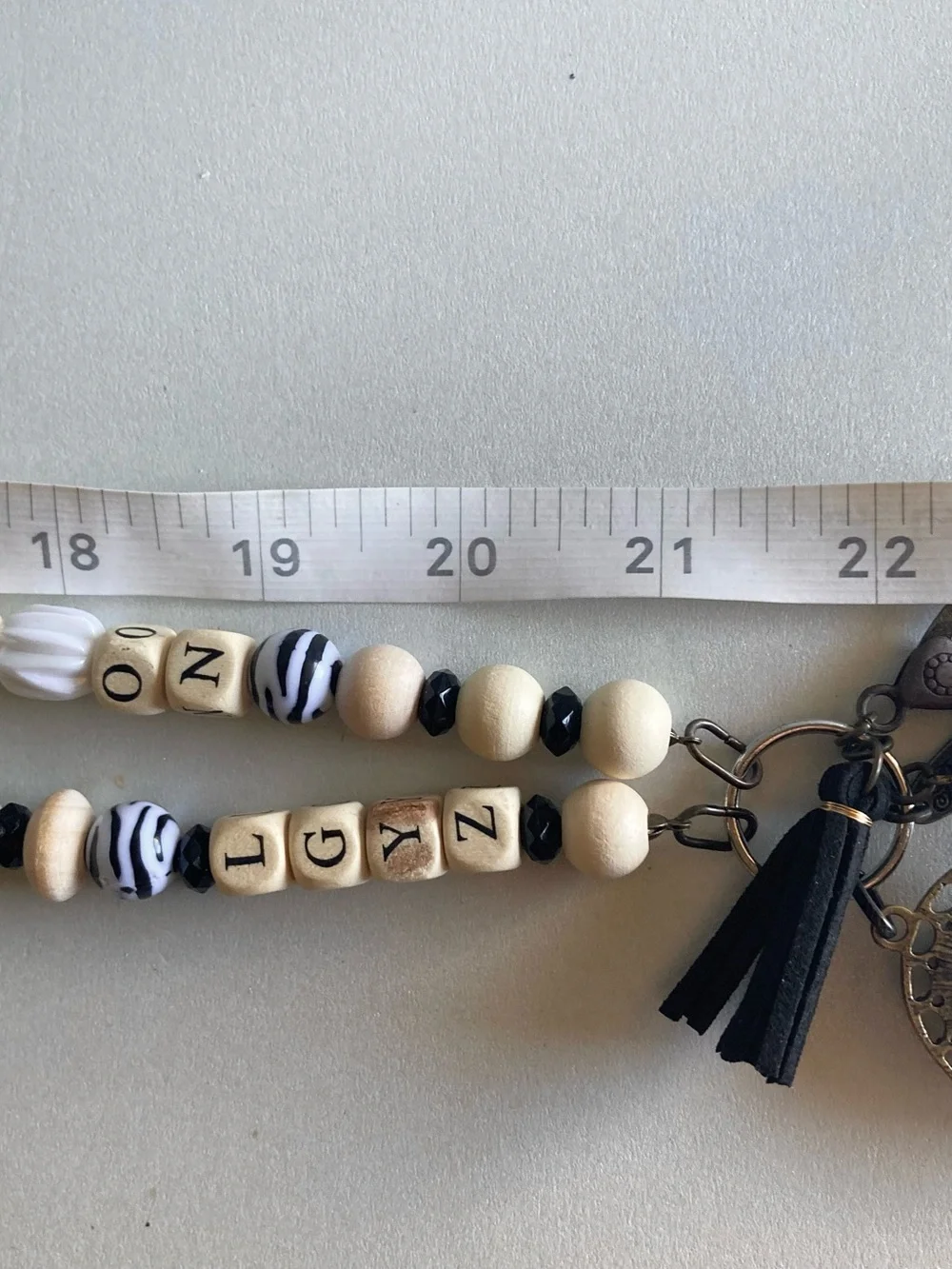 NWOT Plunder Black and Cream Beaded Pendant lanyard with Inspirational Charm